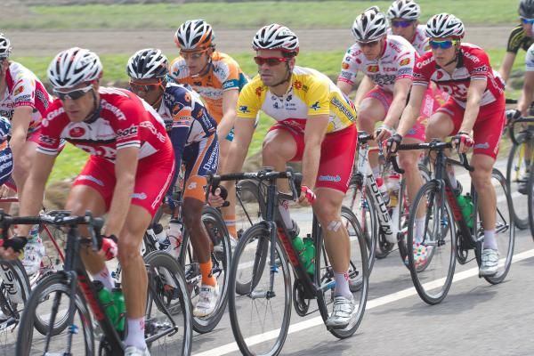 Yellow jersey Rhys Pollock escorted by his Drapac team