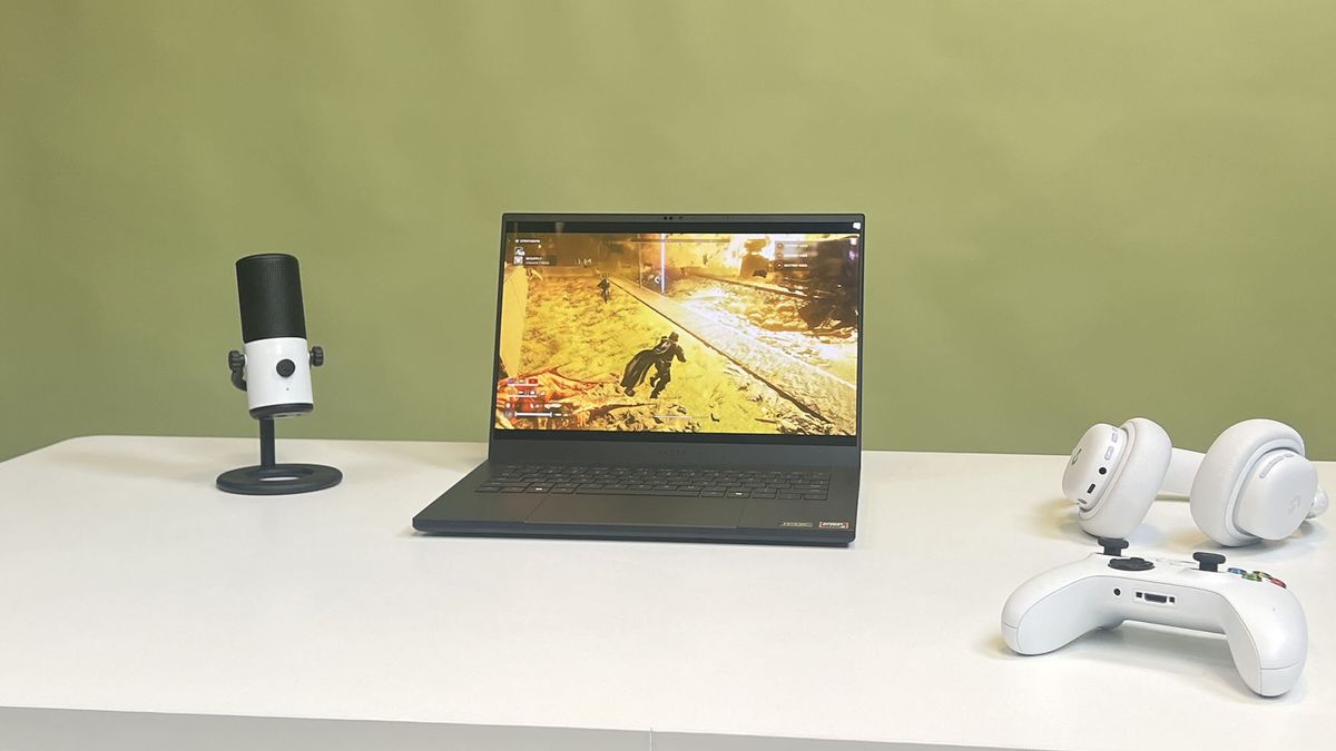 Helldivers 2 playing on a Razer Blade 14 (2025) that is surrounded by gaming peripherals