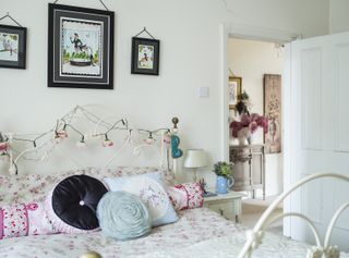 White bedroom with fairy lights and display