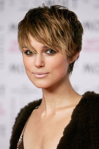 Keira Knightley is pictured with a pixie cut and bangs as she arrives at the Moet & Chandon Fashion Tribute award at the biennial awards ceremony recognising excellence in the fashion industry, during London Fashion Week Autumn/Winter 2005/6 at Old Billingsgate Market on February 16, 2005 in London. The award goes to a UK designer who has influenced the fashion world on an international level.