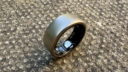 The Amazfit Helio smart ring pictured on a concrete surface.