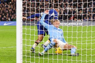 Manchester City's Erling Haaland scores their third goal during the Premier League match between Chelsea FC and Manchester City at Stamford Bridge on November 12, 2023 in London, United Kingdom. (Photo by Marc Atkins/Getty Images)