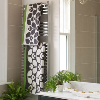 bathroom with patterned towels and mirror