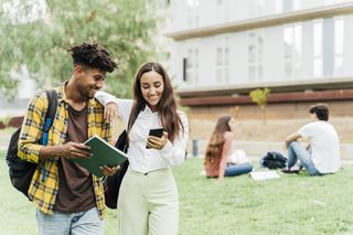 Two university students walking out of class together.