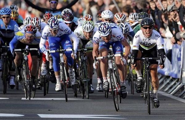 Mark Cavendish (Sky) crosses the line victorious at Kuurne-Brussel-Kuurne.