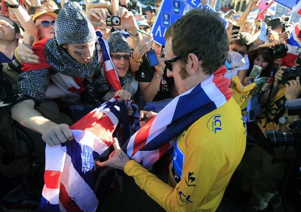 2012 Tour de France champion Bradley Wiggins (Sky) signs some autographs.