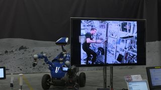 Andreas Mogensen, aboard the International Space Station, is visible here controlling the Interact rover as it prepared to place a metal peg into a hole.