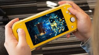 Hands holding a console and playing one of the best Nintendo Switch Lite games
