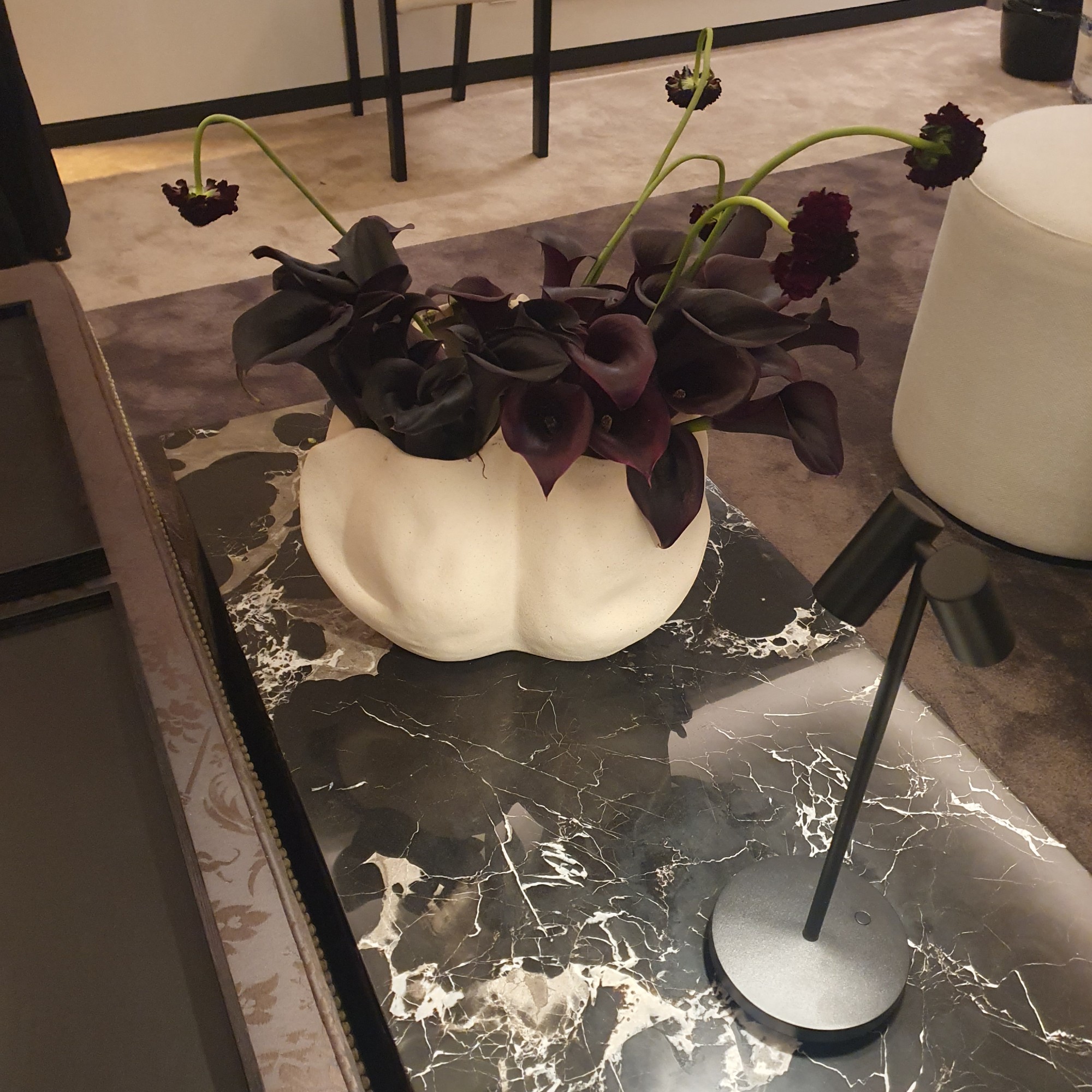 A space designed by Kelly Hoppen at Design Centre's WOW!house event featuring a vase of midnight calla lilies