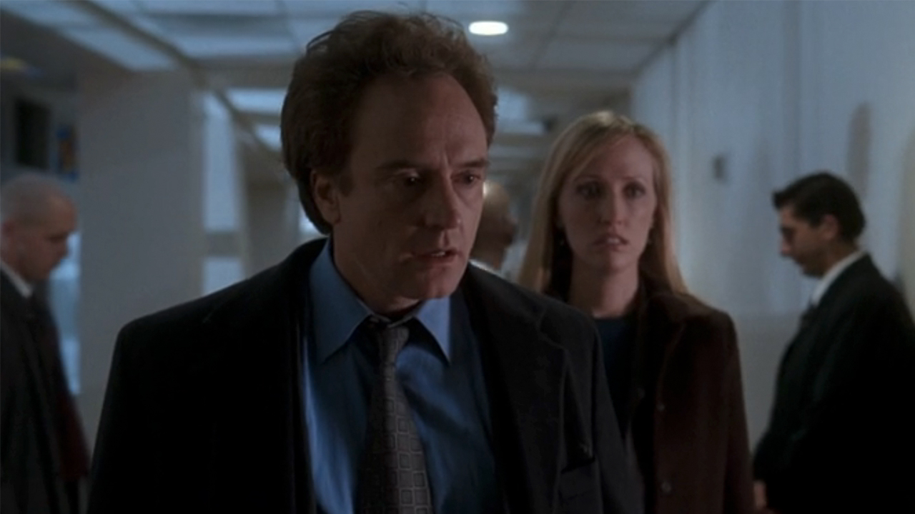 Bradley Whitford in a suit looking stunned on The West Wing