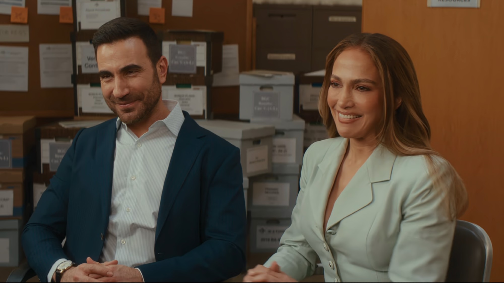 Brett Goldstien and Jennifer Lopez smiling in Office Romance. 