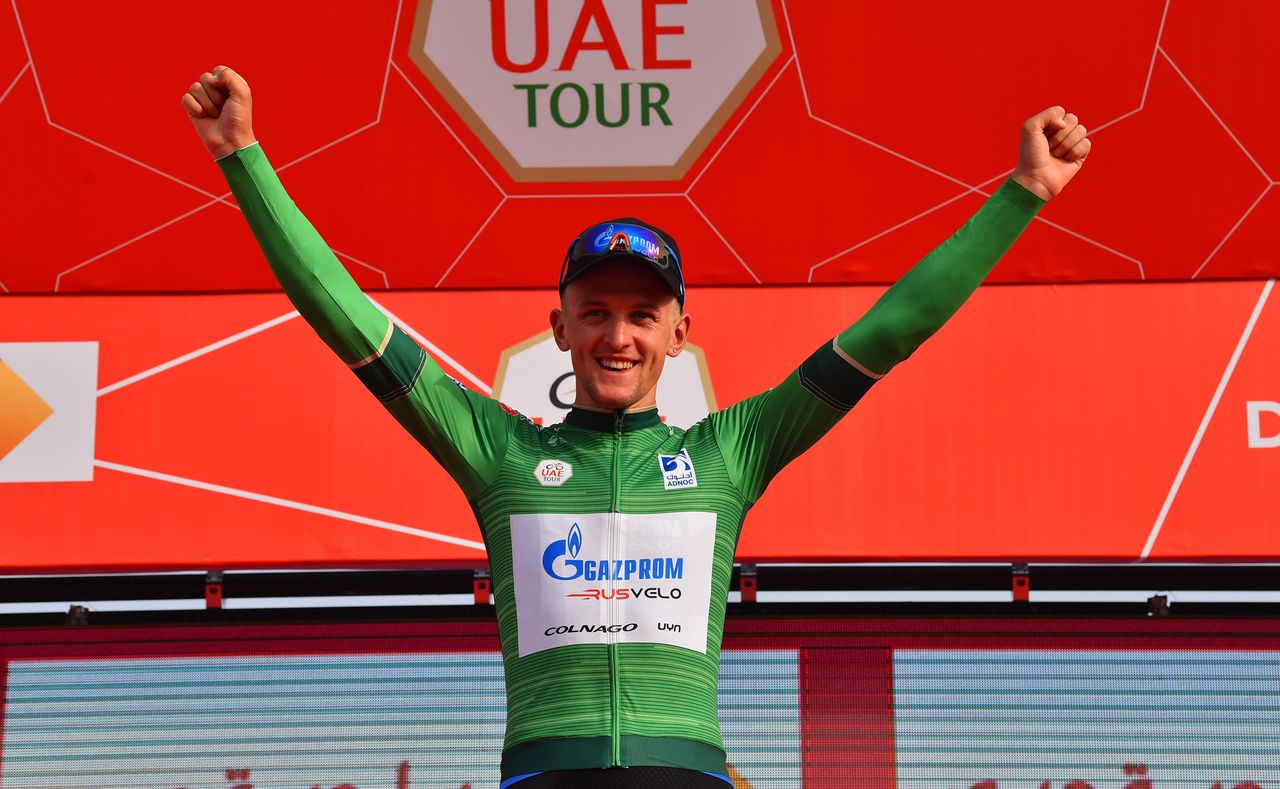 Stepan Kurianov pulls on the green jersey as leader of the points classification