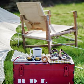camping with red metal storage box