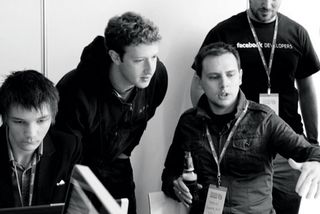 Mark Zuckerberg and Steve Folkes share a discussion about an app under development at a Facebook Hackathon event in London 2010