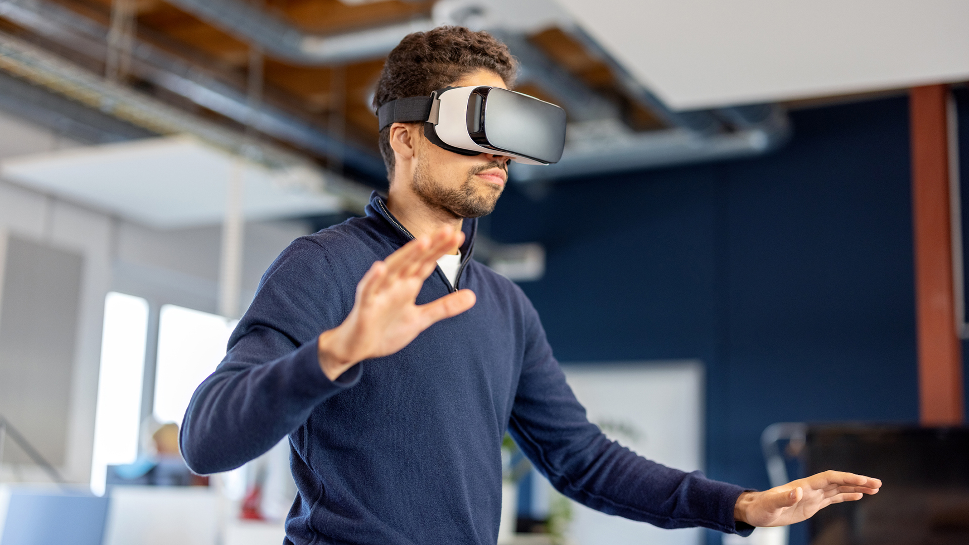 A businessperson wearing an XR or VR headset inside a modern office.