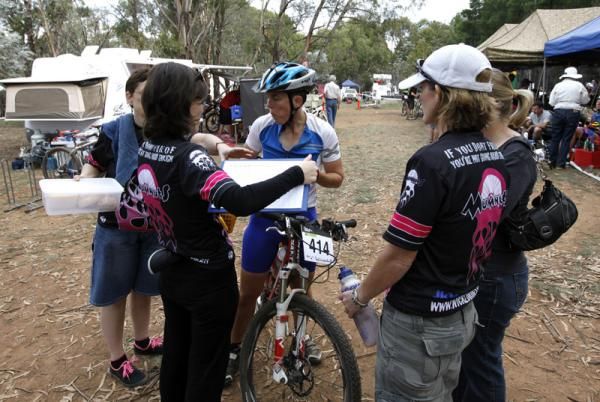 Merryl King (13th) gets an update from her support crew in the pits.
