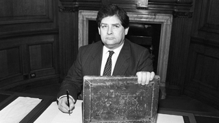 Black and white image of Nigel Lawson with his budget box in 1989