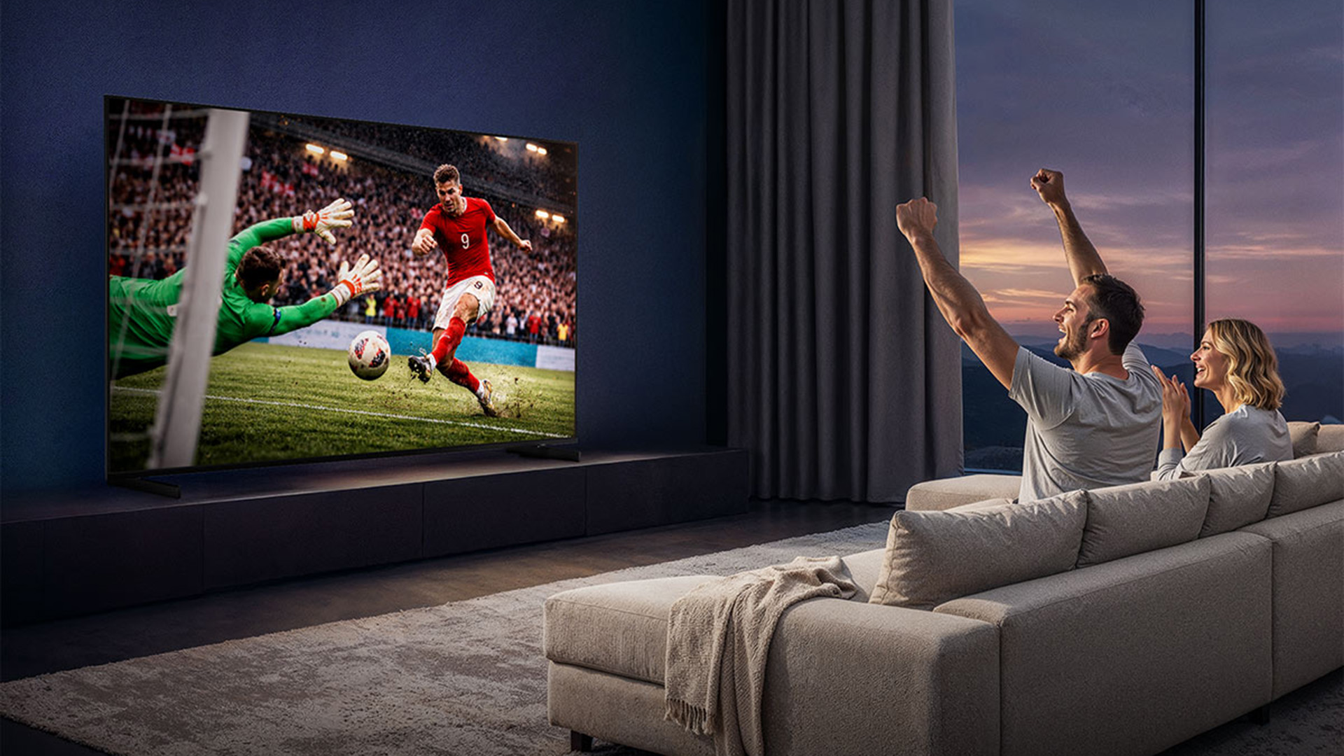 A couple watching football on a TV screen.