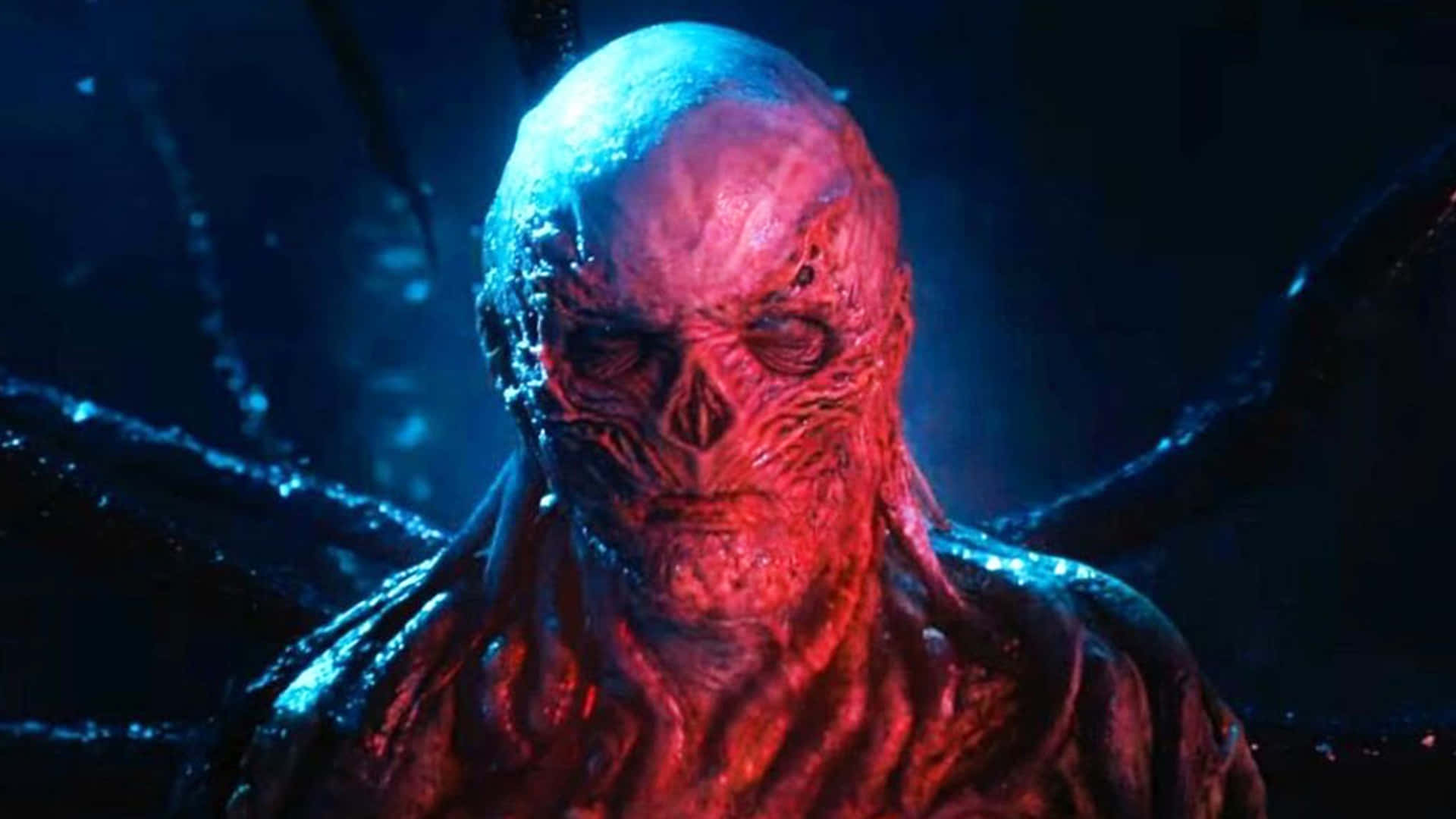 A close up shot of Vecna bathed in red light in Stranger Things season 4