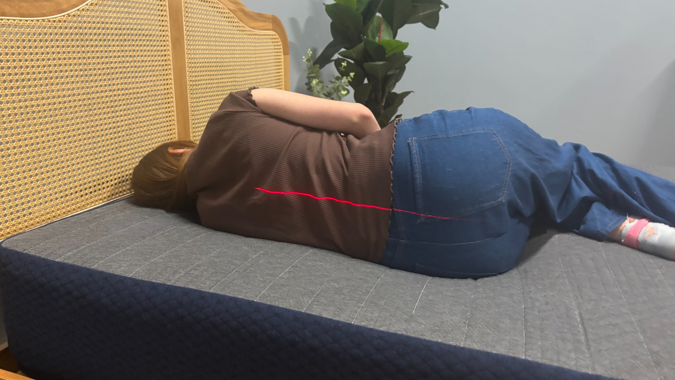 A woman side sleeps on the Brooklyn Bedding CopperFlex Essential Mattress.