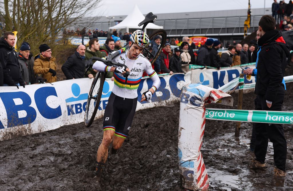 Wout Van Aert carrying his bik