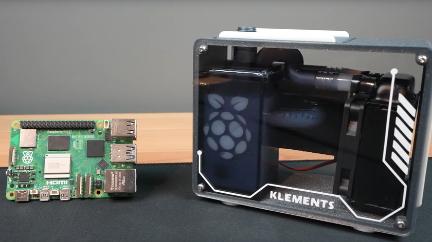 Michael Klements&#039; custom Raspberry Pi 5 case with Pi 5 open loop rebuilt within hyper compact case, beside a regular Pi 5.