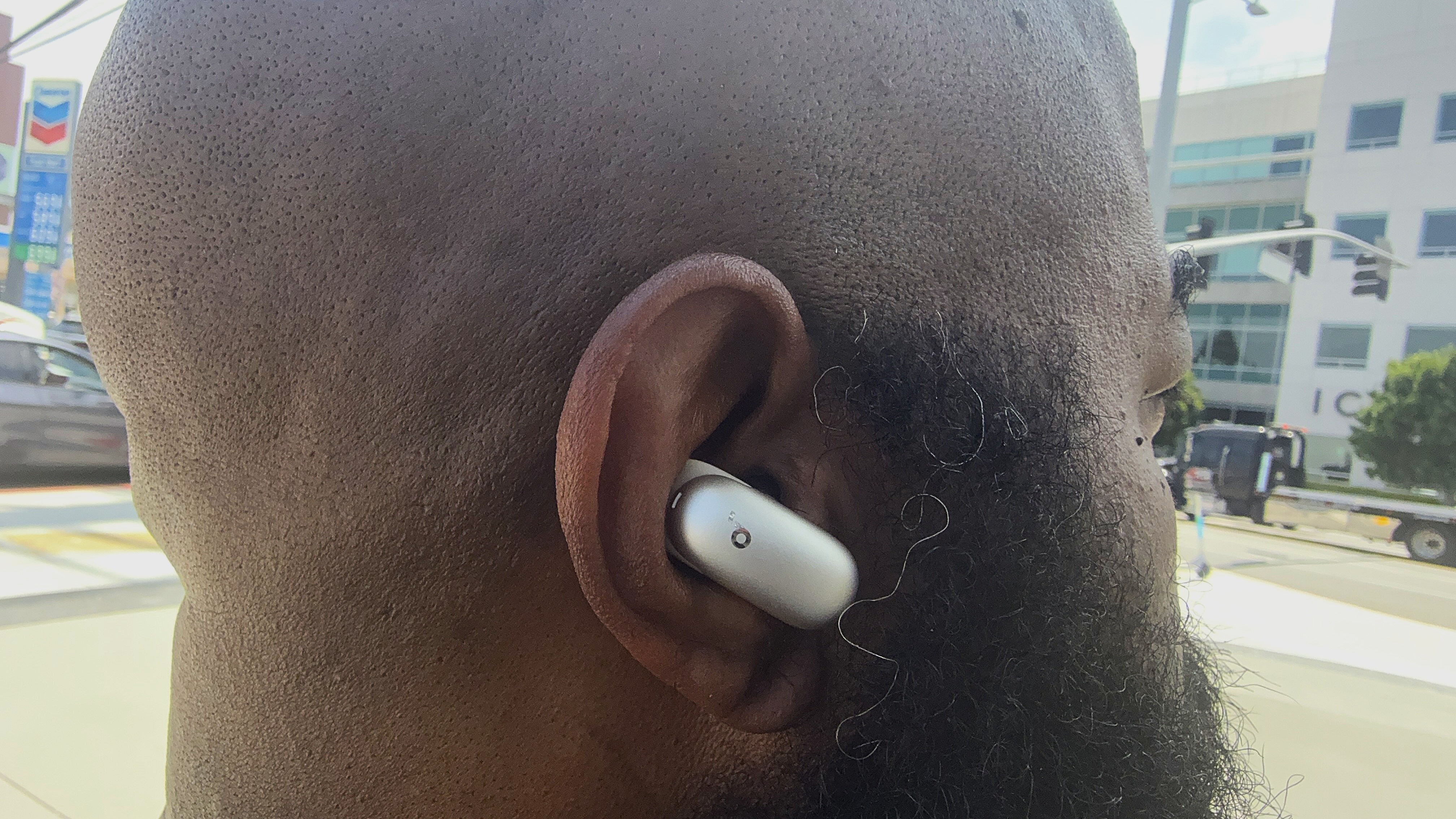 Reviewer wearing the Soundcore Liberty 5 Pro Max on a busy metropolitan street