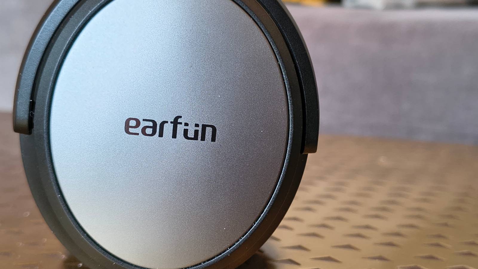 The Earfun Tune Pro atop a bronze table.