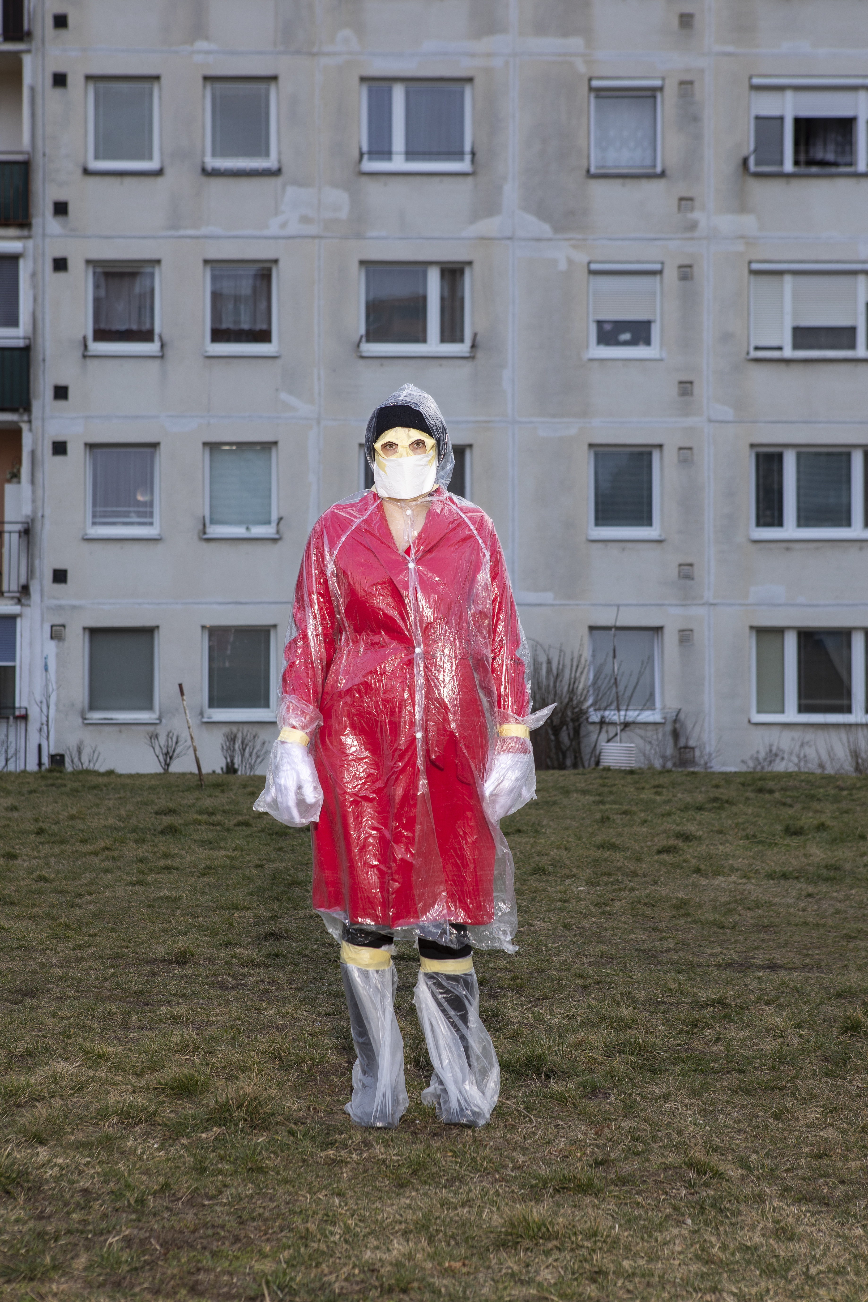 person in mask and red coat