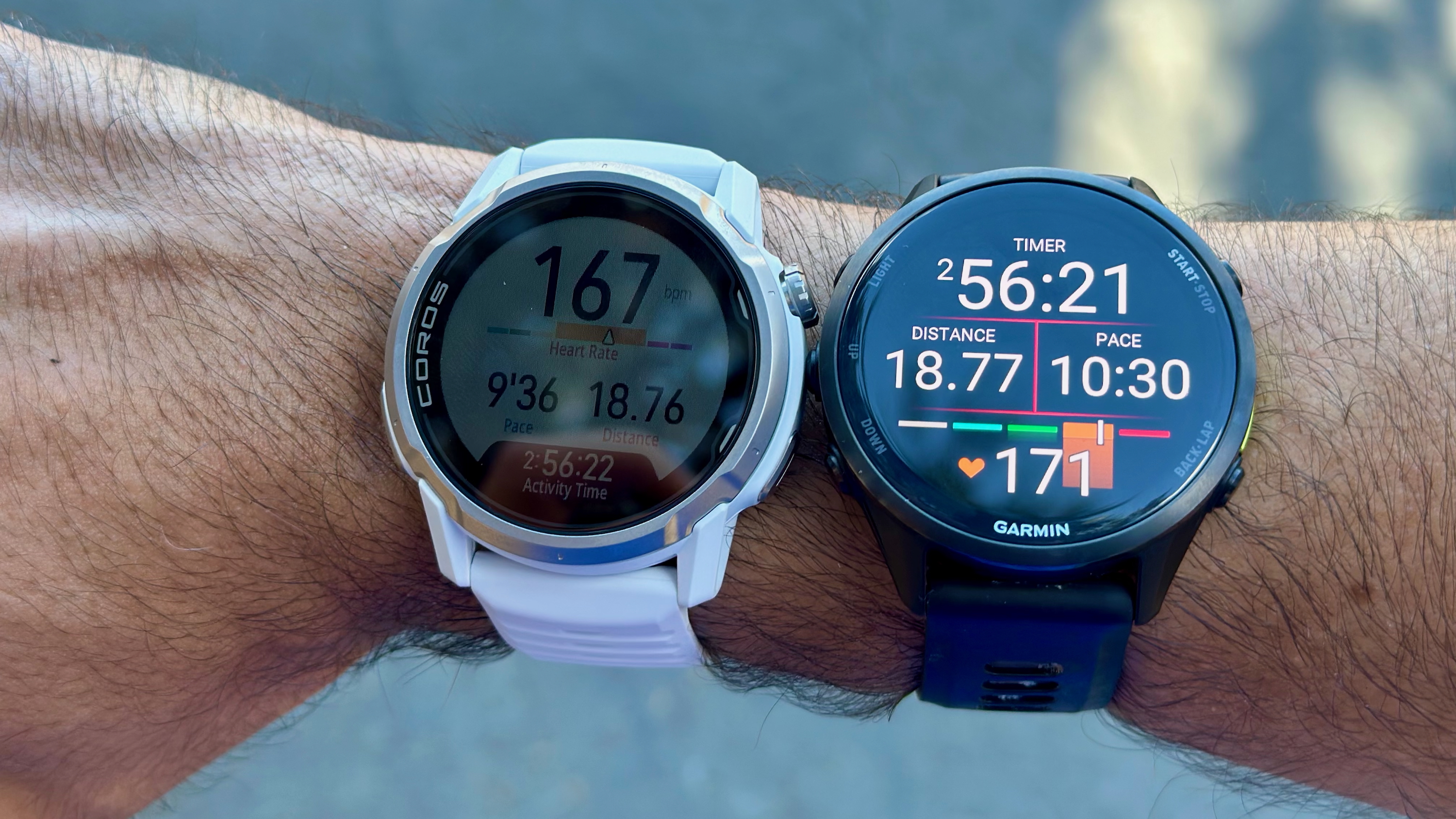 A photo of the COROS APEX 4 and Garmin Forerunner 970 on the same wrist, for comparing GPS and HR data in the same workout. COROS&#039;s distance data is 0.01mi lower, while its current HR is 3 bpm lower.