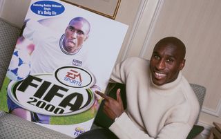 Sol Campbell holding up an image of himself on the cover of FIFA 2000