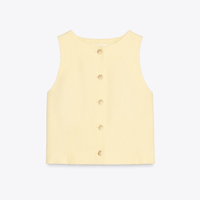 A cut out of a butter yellow waistcoat from Zara