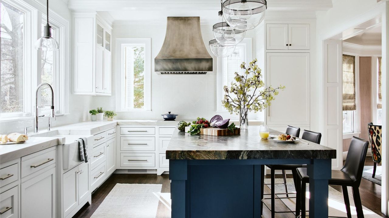 kitchen with white cabinets and blue island