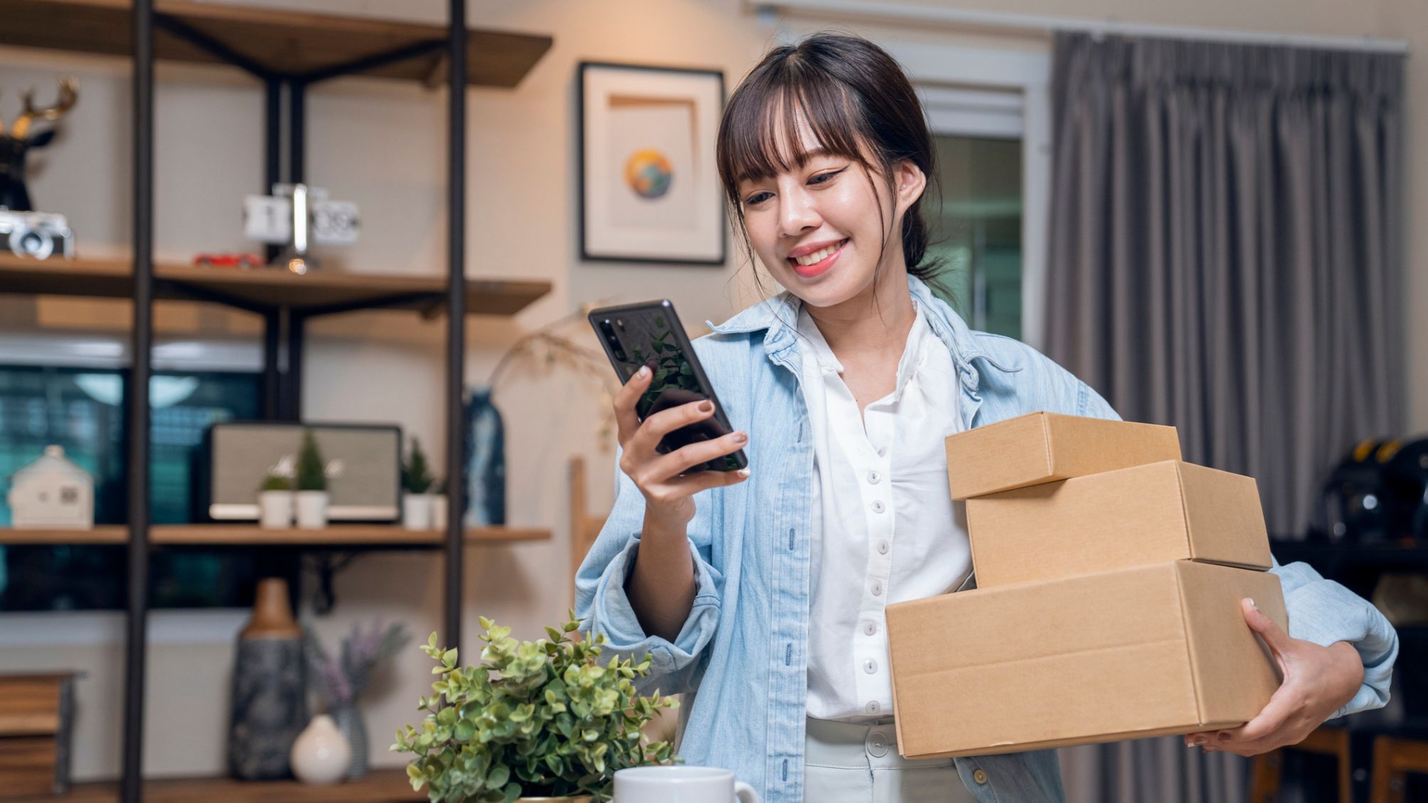 A woman is preparing to ship several packages.