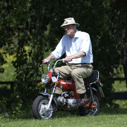 Prince Philip riding a motorcycle 