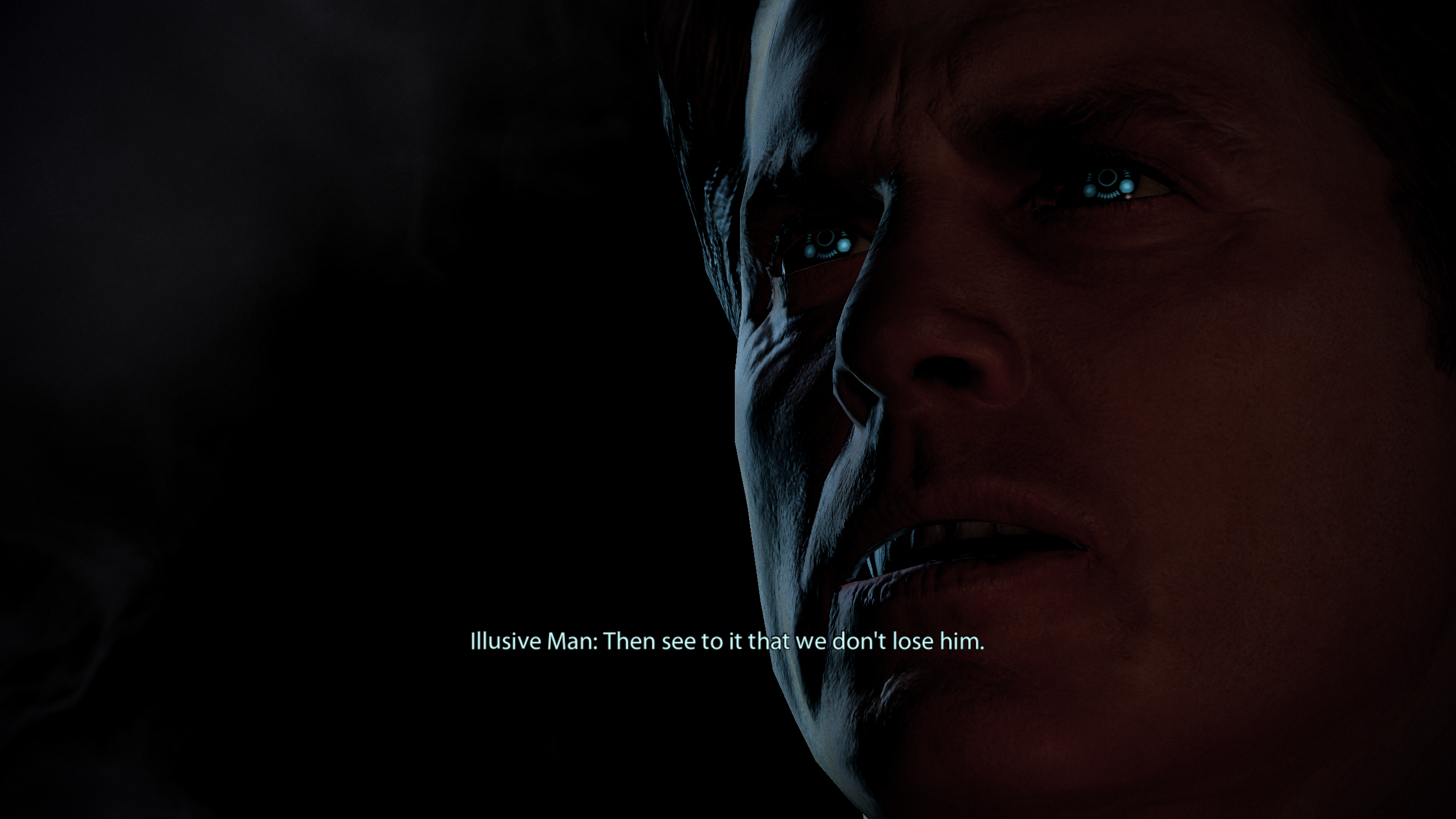 A closeup on The Illusive Man's face as he delivers a line of dialogue