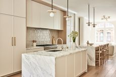 White kitchen cabinets with zellige tiles