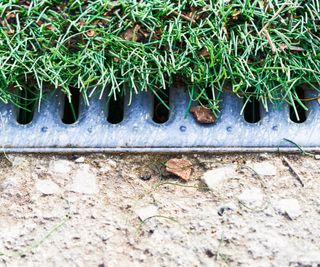 A close up of a trench drain in a yard