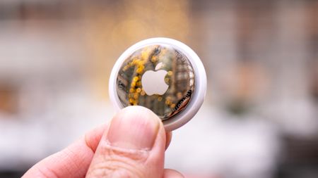 Apple AirTag 2 held in the hand.