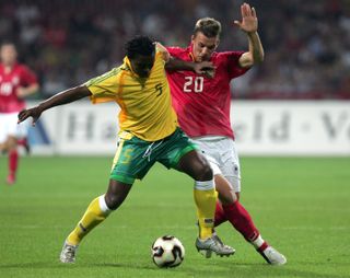 South Africa's Mbulelo Mabizela competes for the ball with Germany's Lukas Podolski in a friendly in September 2005.