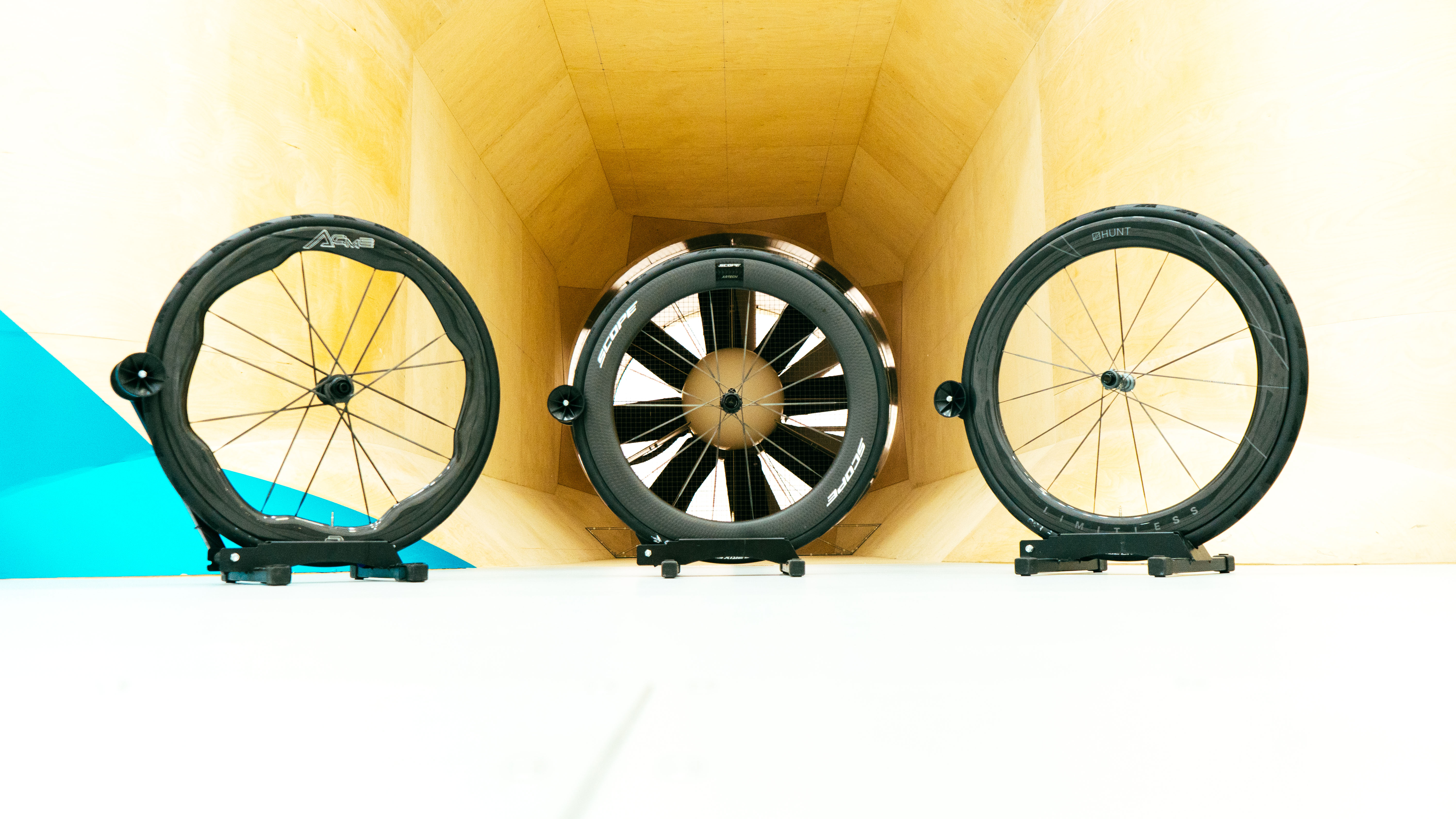 Three wheels sit in front of the fan in the wind tunnel