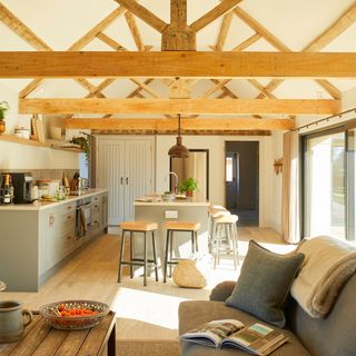 kitchen room with wooden beams and sofa with cushion and book