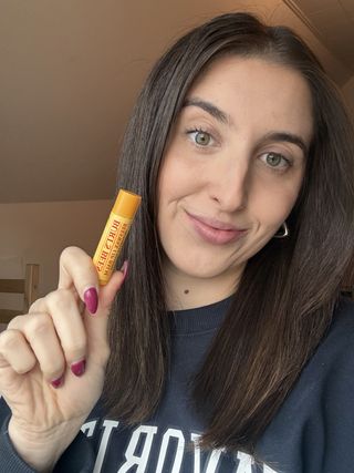 Marisa holding the Burt's Bees Moisturizing Lip Balm