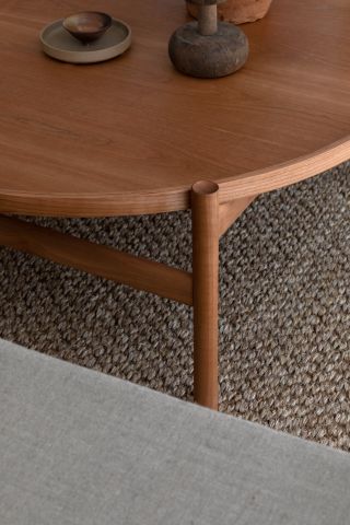 A partial view of a brown coffee table.