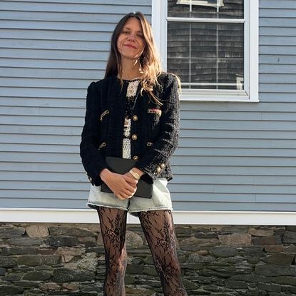 Julia Gall wearing a black tweed blazer, denim shorts, and lace tights