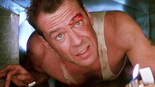 Bruce Willis as John McClane crawling through a vent during Die Hard