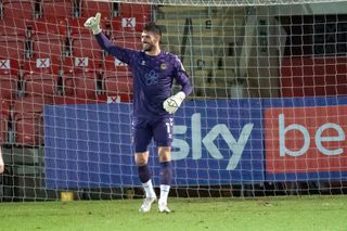 Goalkeeper Tom King celebrates after scoring from a goal-kick for Newport County against Cheltenham Town, 2021