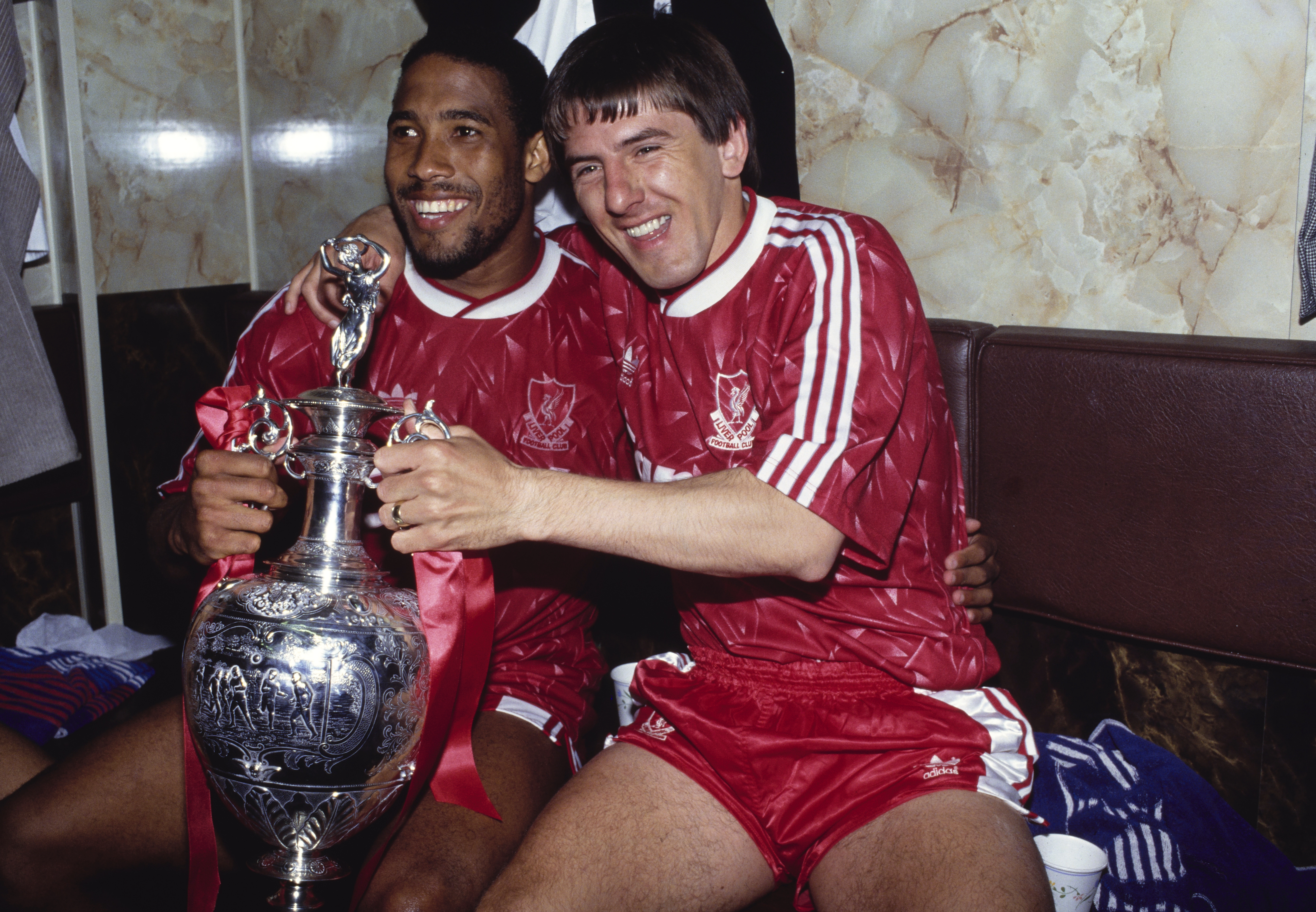 Liverpool pair John Barnes and Peter Beardsley celebrate with the First Division trophy in May 1990.