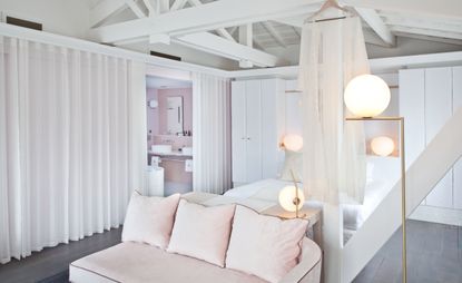 Room with chair having light pink cushions