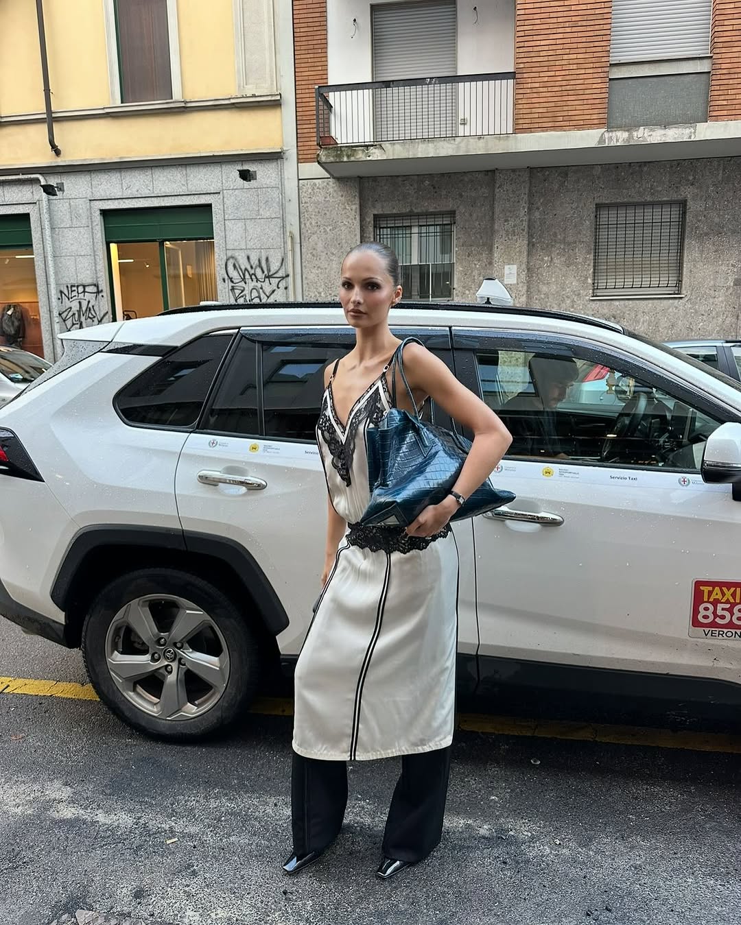 woman wearing dress over pants fall outfit 2025